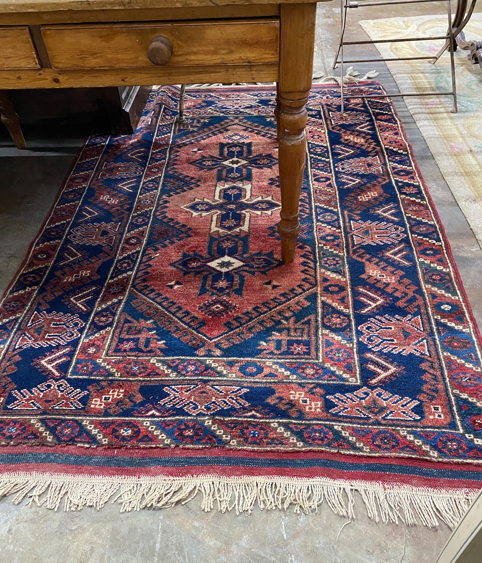 A Caucasian style red ground rug, 184 x 130cm